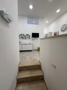 a room with a staircase and a tv in it at Da Silvi Apartment in Terracina +4 photos