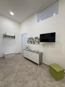 a large room with a flat screen tv on a wall at Da Silvi Apartment in Terracina