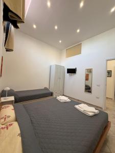 a bedroom with a bed with two towels on it at Da Silvi Apartment in Terracina