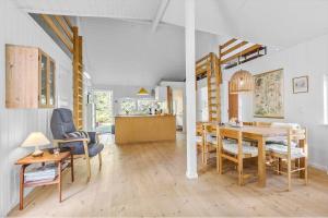 a dining room and living room with a table and chairs at 8552-Grenaa-Polderrevsvej-17 in Grenå