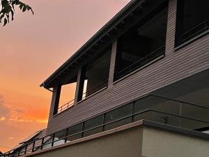 a building with a sunset in the background at Apartment Wiedehopf in Vogtsburg