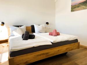 a large bed with white sheets and pillows on it at Apartment Wiedehopf in Vogtsburg