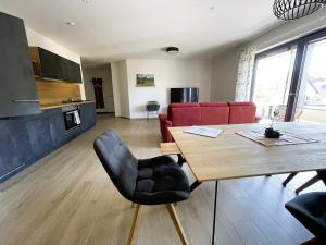 a living room with a table and a couch at Apartment Wiedehopf in Vogtsburg