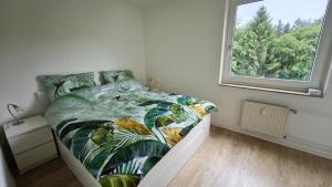a small bedroom with a bed with a window at HochDrei - Hahnenklee in Goslar +12 photos