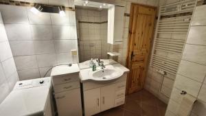 a bathroom with a sink and a washing machine at HochDrei - Hahnenklee in Goslar