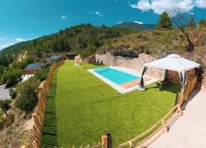 an external view of a villa with a swimming pool at Casa Rural Molí de Fòrnols in Fornols