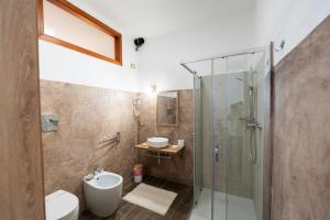 a bathroom with a shower and a toilet and a sink at Miluna Affittacamere in Siniscola +58 photos