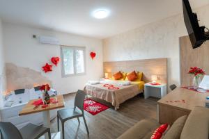 a bedroom with a bed and a living room at Miluna Affittacamere in Siniscola