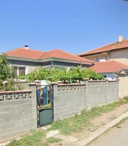 a fence with a gate in front of a house at Pomorie appartement ad in Pomorie