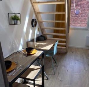 a table and chairs in a room with a staircase at Pomorie appartement ad in Pomorie