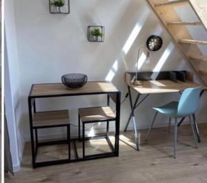 a table and a chair next to a table and a desk at Pomorie appartement ad in Pomorie +3 photos