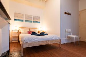 a bedroom with a bed with two towels on it at a charming little apartment in Cluny