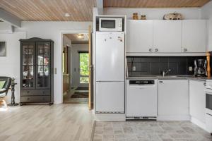 a kitchen with white cabinets and a refrigerator at LF12011-Spottrup-Vadumvej-1-E in Spottrup +10 photos