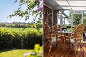 a patio with a table and chairs on a deck at LF12011-Spottrup-Vadumvej-1-E in Spottrup