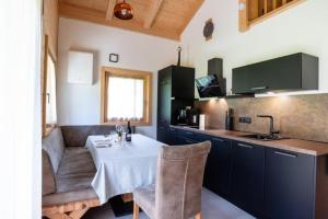 a kitchen with a table and chairs in a room at Chalet am Zirm in Riobianco