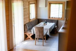 a dining room with a table and chairs and windows at Chalet am Zirm in Riobianco