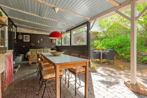 a patio with a table and chairs on a patio at 8965-Allingabro-Hasselvej-3 in Skovgårde