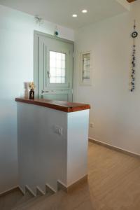 a kitchen with a white counter and a window at Amara Serifos in Serifos Chora +16 photos