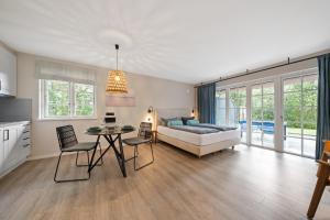a living room with a couch and a table at Beach Lodge Beach Lodge Appartement 6 in Böhl