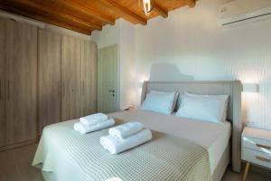 a bedroom with a bed with two towels on it at Amara Serifos in Serifos Chora
