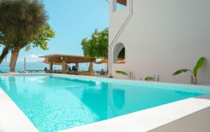 a swimming pool in a villa with a view of the ocean at Newquay beach club in Kavos