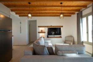 a living room with a couch and a tv at Amara Serifos in Serifos Chora