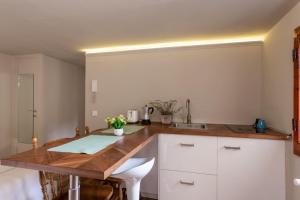 a kitchen with white cabinets and a wooden counter top at Central Gucciardini house in Florence