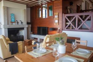 a living room with a table and a fireplace at Casa Martagão do Gerês by Gerês Casas in Caniçada