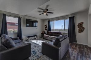 a living room with two couches and a ceiling fan at Executive Stay for Work & Family in Rapid City