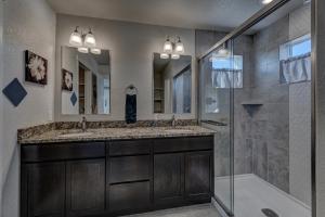 a bathroom with two sinks and a shower at Executive Stay for Work & Family in Rapid City +42 photos