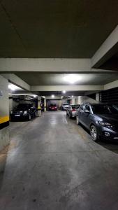 a parking garage with cars parked in it at Estúdio Paris Lagoa Santa in Lagoa Santa +1 photo