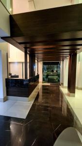 a lobby with a wooden ceiling and black floor at Estúdio Paris Lagoa Santa in Lagoa Santa