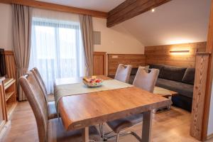 a living room with a wooden table and a couch at Altroiterhof in St. Wolfgang