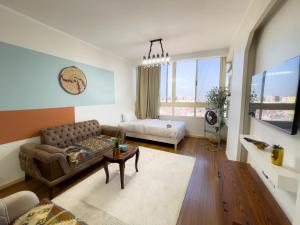 a living room with a couch and a table at Luxurious GEM and PYRAMIDS view in Cairo