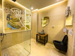 a bathroom with a shower and a toilet and a sink at Luxurious GEM and PYRAMIDS view in Cairo +129 photos