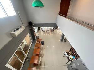 an overhead view of a staircase in a room with tables and chairs at Bann Lhong Rak Krabi in Krabi
