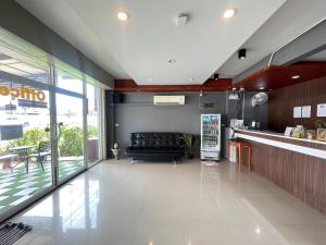 a lobby of a restaurant with a couch in the middle at Bann Lhong Rak Krabi in Krabi