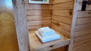 a sauna with two towels sitting on a shelf at Blue Spruces Cottages in Hampton  +107 photos