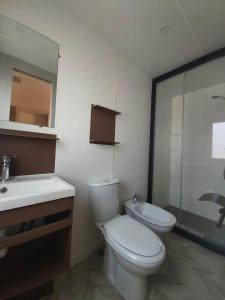 a bathroom with a toilet and a sink and a mirror at Campeggio Internazionale Frassanito in Otranto