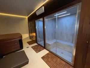 a shower with a glass door in a bathroom at Guest House Pod Slavnikom in Podgorje +23 photos