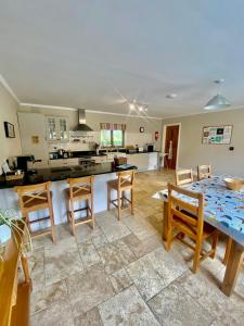a kitchen and living room with a table and chairs at Decoy Country Cottages in Navan