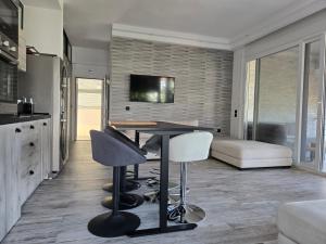 a kitchen and living room with a table and chairs at Villa Mare Lux in Nea Fokea
