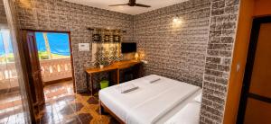 a room with a bed and a tiled wall at Samhen guest house in Majorda