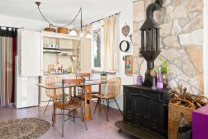 a kitchen and dining room with a table and chairs at Apartman Mafini in Krašići +13 photos