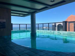 a swimming pool on the roof of a building at Brasil Tropical Luxury Ocean View in Fortaleza