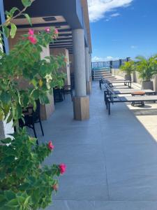 a balcony with benches and flowers on a building at Brasil Tropical Luxury Ocean View in Fortaleza