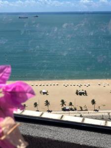 a view of a beach with palm trees and the ocean at Brasil Tropical Luxury Ocean View in Fortaleza