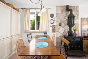 a dining room with a wooden table with blue plates on it at Apartman Mafini in Krašići
