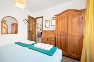 a bedroom with a bed and a wooden cabinet at Apartman Mafini in Krašići