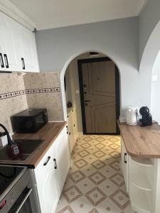 a kitchen with an archway leading to a door at Pavels Cozy Nook in Smolyan